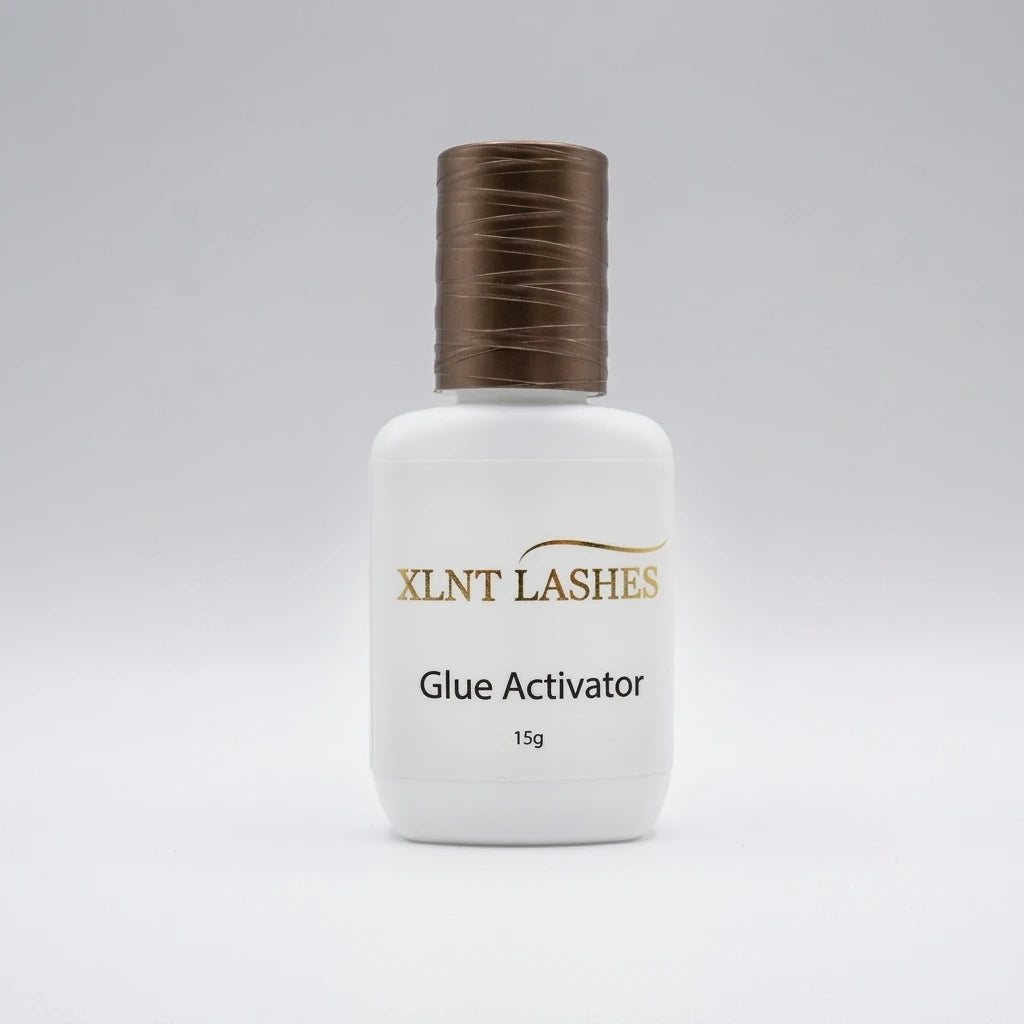 XLNT Lashes Glue Activator 15g bottle with textured bronze cap, lash extension adhesive accelerator.
