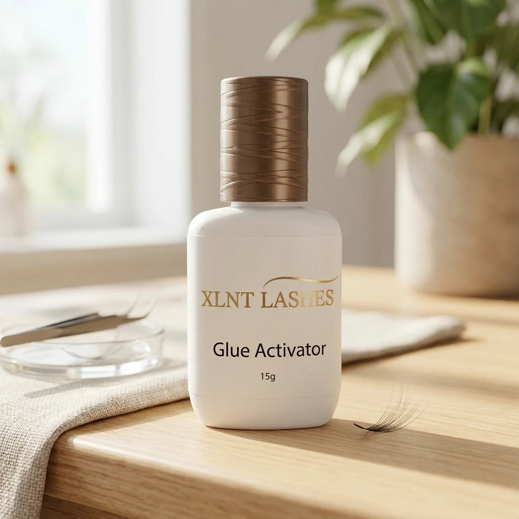 XLNT Lashes Glue Activator 15g eyelash adhesive accelerator bottle on wood table with tweezers.