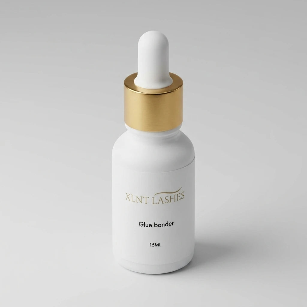 XLNT Lashes Glue Bonder 15ml matte white dropper bottle with gold cap for eyelash extensions.