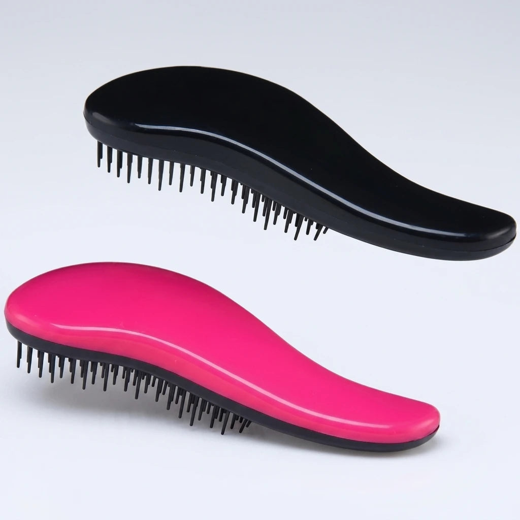 Svart och rosa detangler-borste med flexibla plastpiggar, ergonomisk design för fransförlängning.