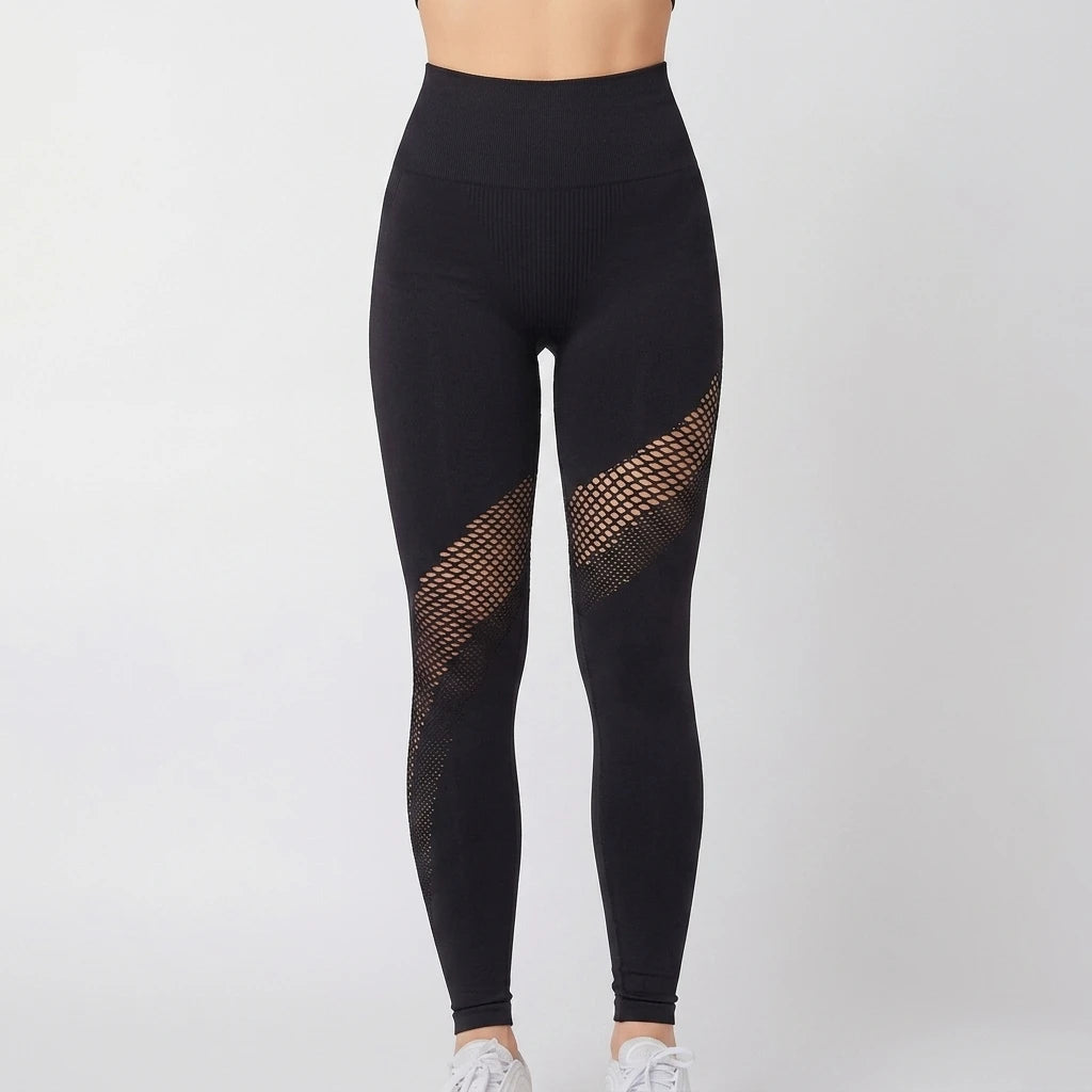 Contour Mesh Tights svart framifrån med diagonala meshpaneler över låren och hög midja mot ljus bakgrund.