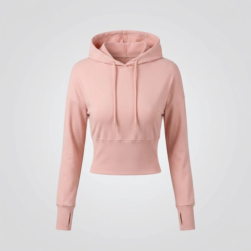 Croppad hoodie i puderrosa med huva, dragskor, bred ribbad midja och tumhål – framsida