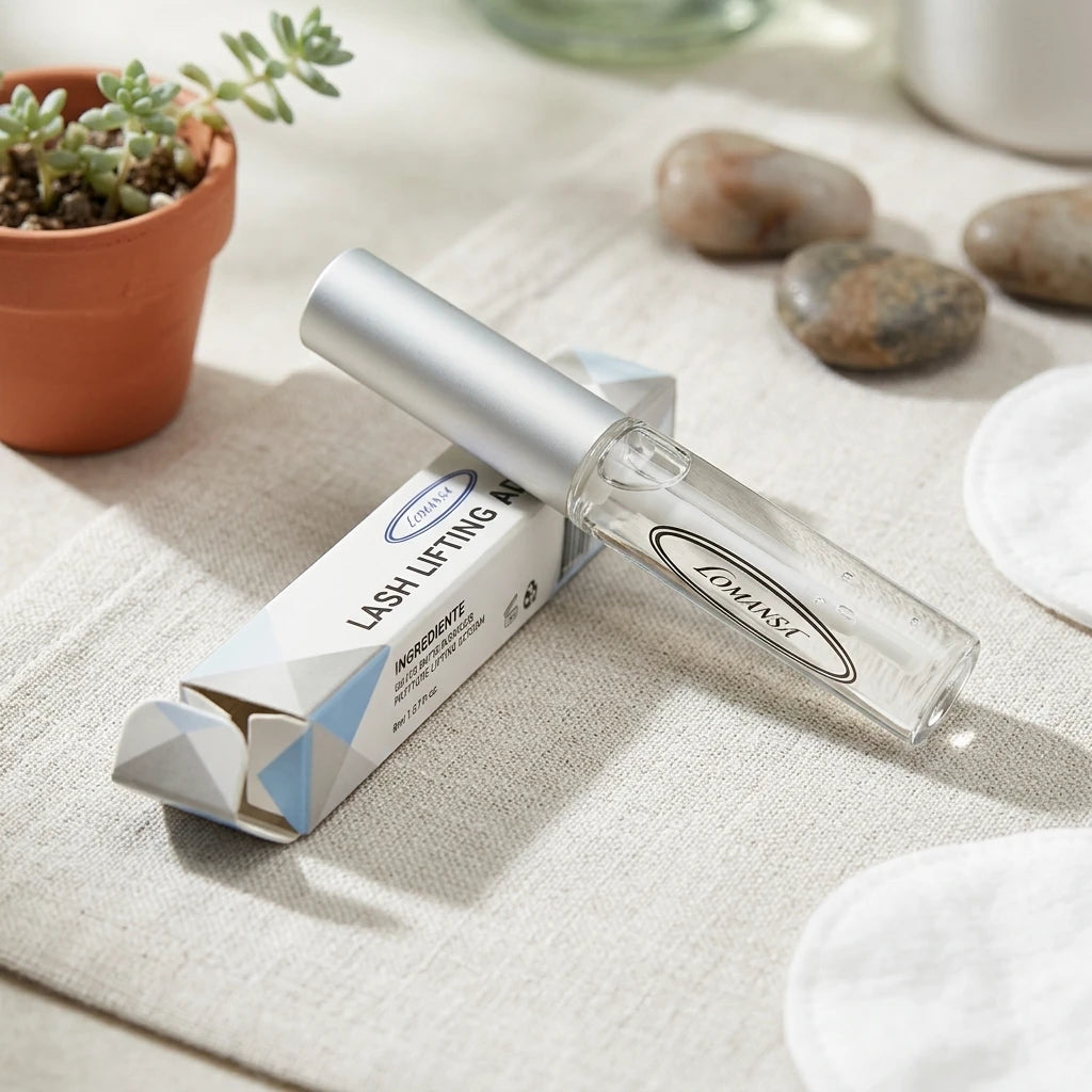 Lomansa lash lifting adhesive clear tube and box on a neutral linen surface with stones and a small succulent.