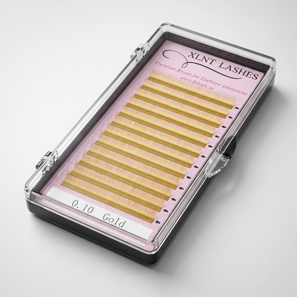 Närbild på Premium Eyebrow Guld brynhår i guldton arrangerade i rader på rosa botten i transparent ask.