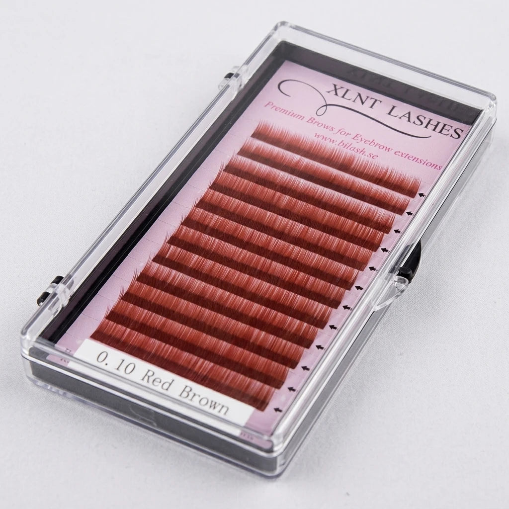 Närbild på rödbruna ögonbrynsstrån ordnade i rader i plastask – Premium Eyebrow från XLNT Lashes.